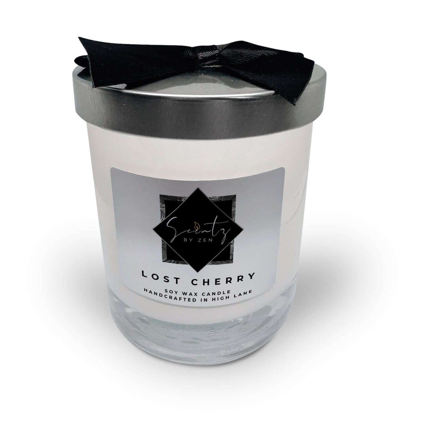 10oz White soy wax candle in a glass jar, labeled "Lost Cherry" topped with a silver lid and black ribbon, handcrafted in High Lane.