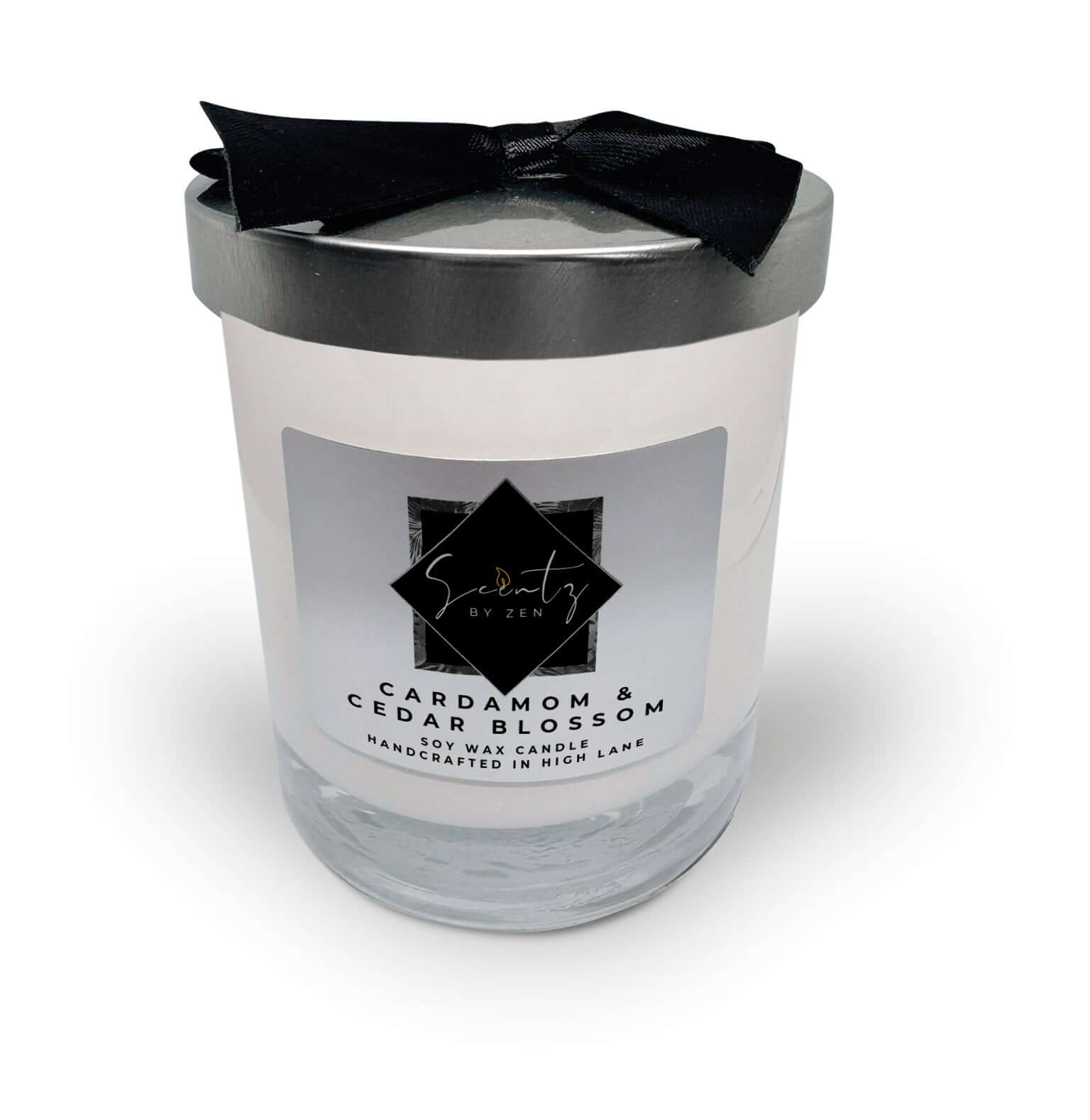 10oz White soy wax candle in a glass jar, labeled "Cardamom & Cedar Blossom" topped with a silver lid and black ribbon, handcrafted in High Lane.