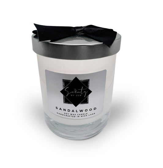 7oz White soy wax candle in a glass jar, labeled "Sandalwood" topped with a silver lid and black ribbon, handcrafted in High Lane.